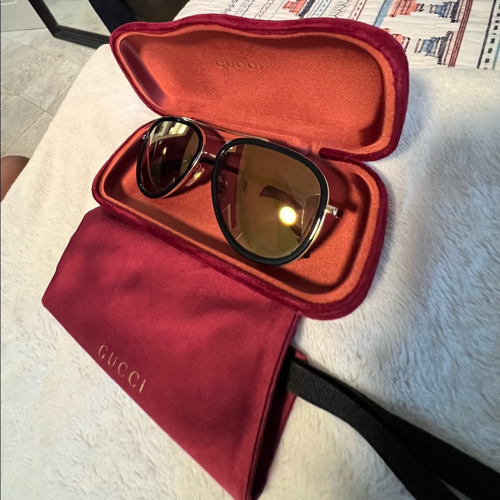 Gucci Black Frame Sunglasses with Gold Accents and Brown Gradient Lenses